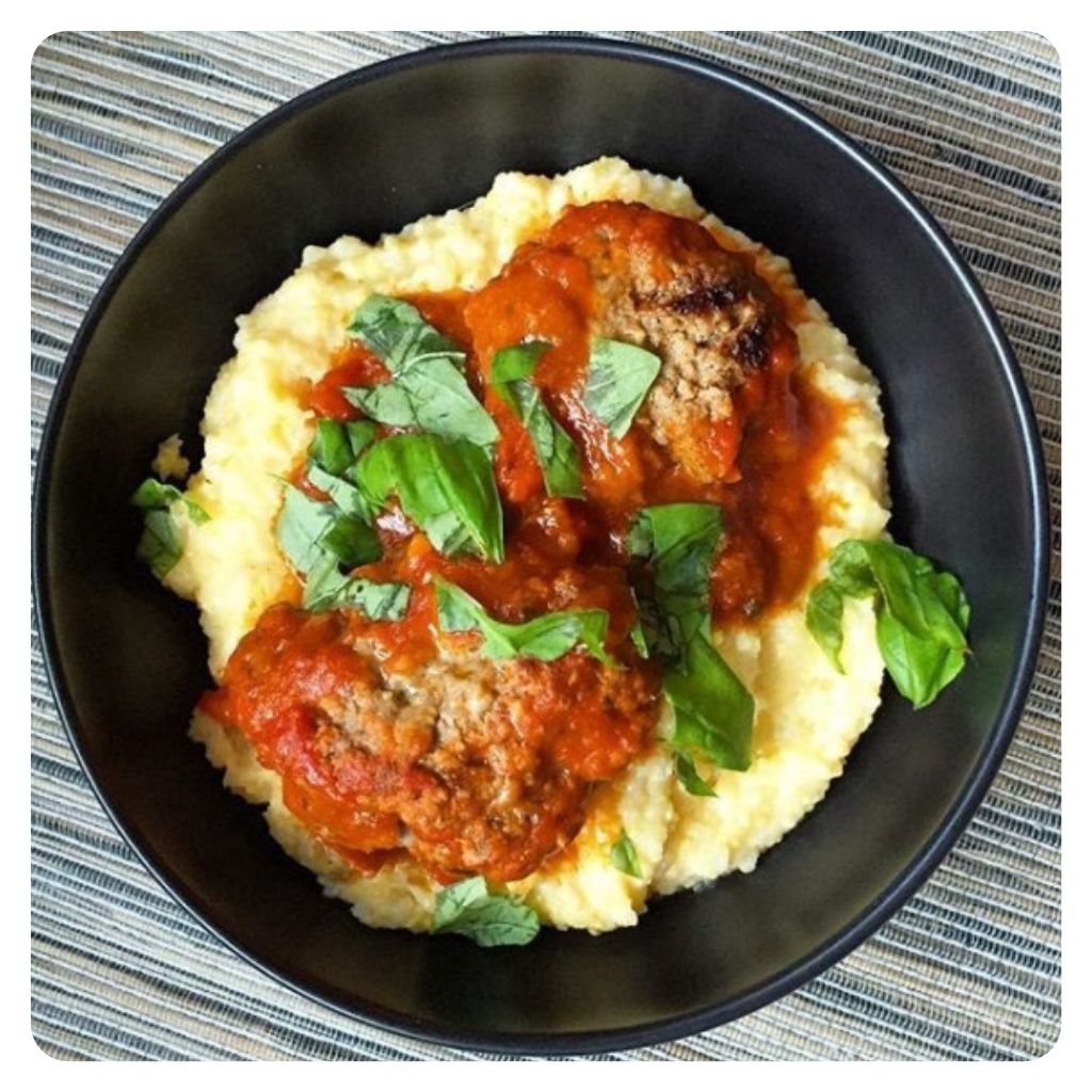 A bowl of meatballs and polenta