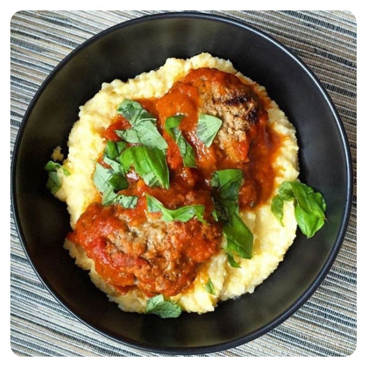 A bowl of meatballs and polenta