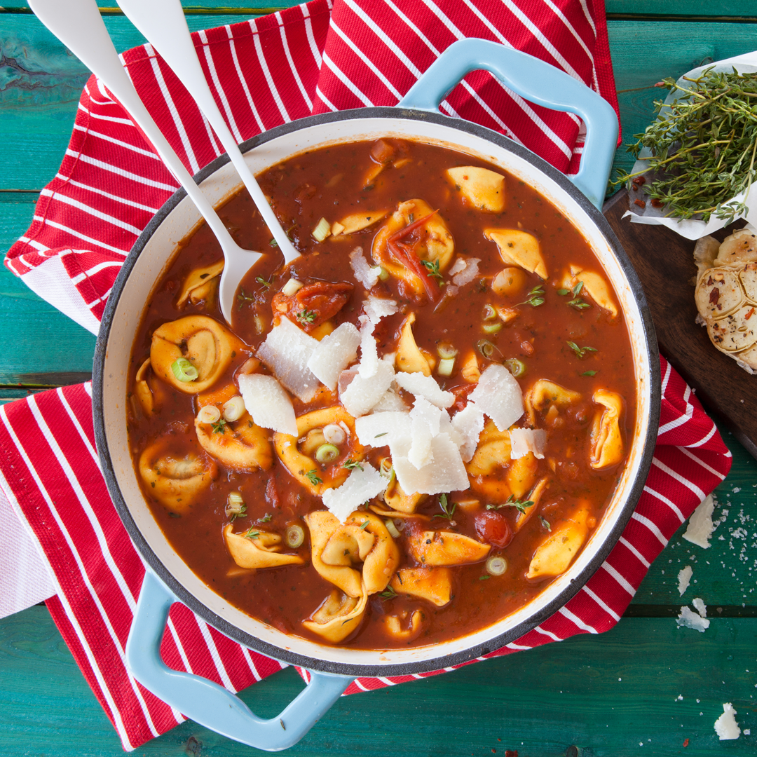 A bowl of tortellini soup