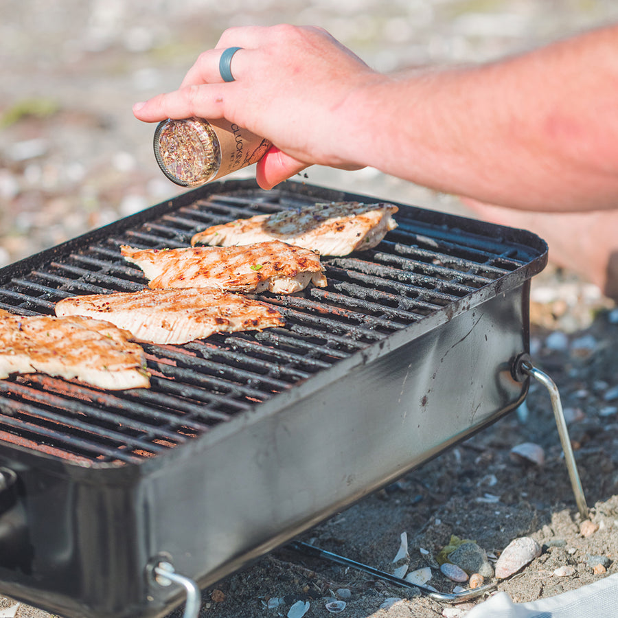 seasoning chicken on the grill