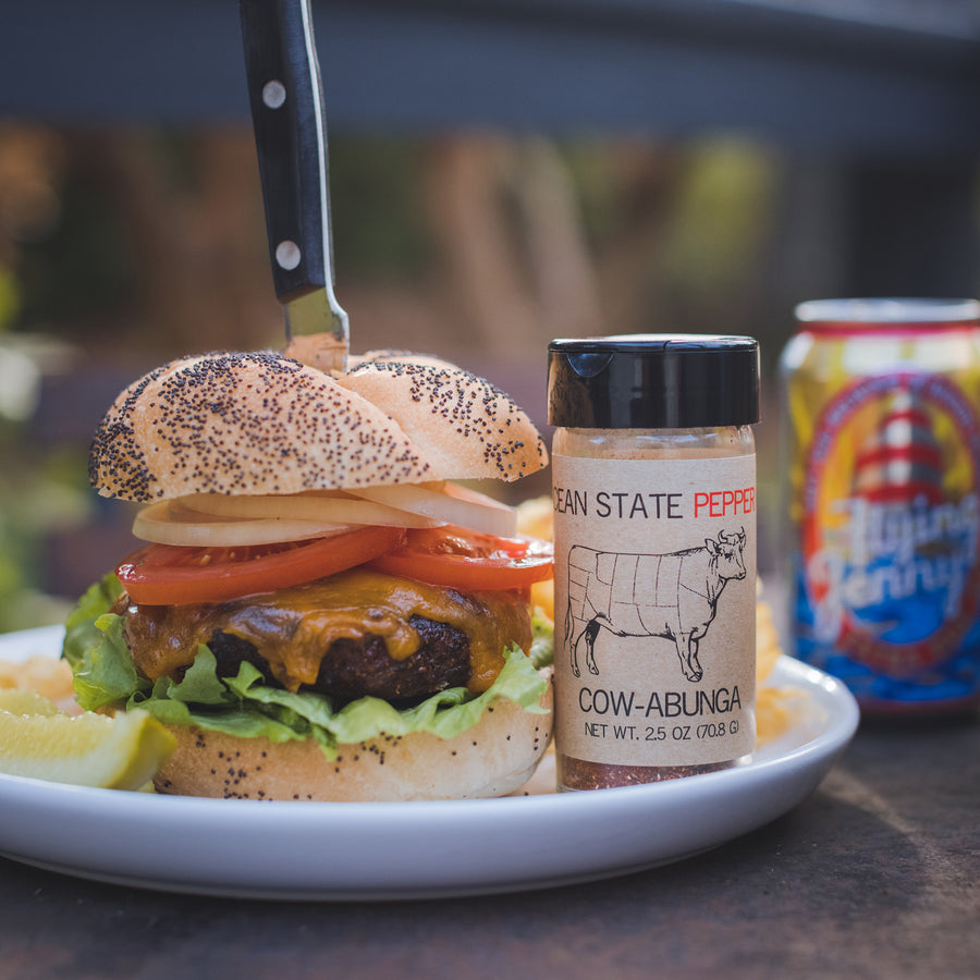 plated burger with seasoning bottle displayed