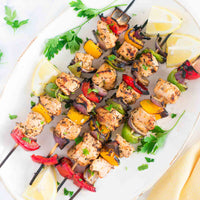 chicken and vegetable kebobs on a platter