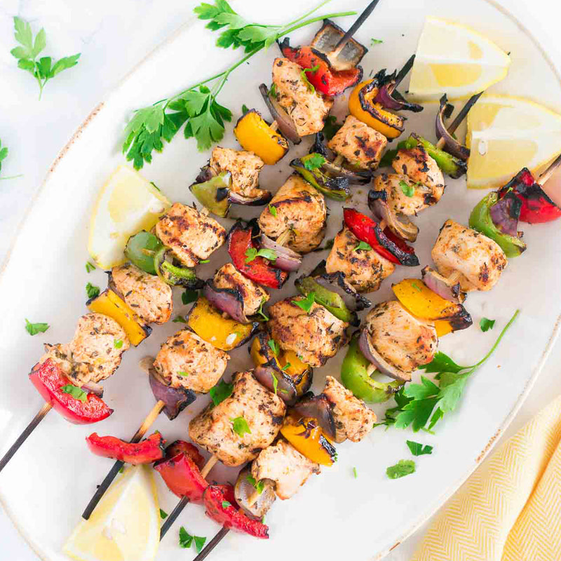 chicken and vegetable kebobs on a platter