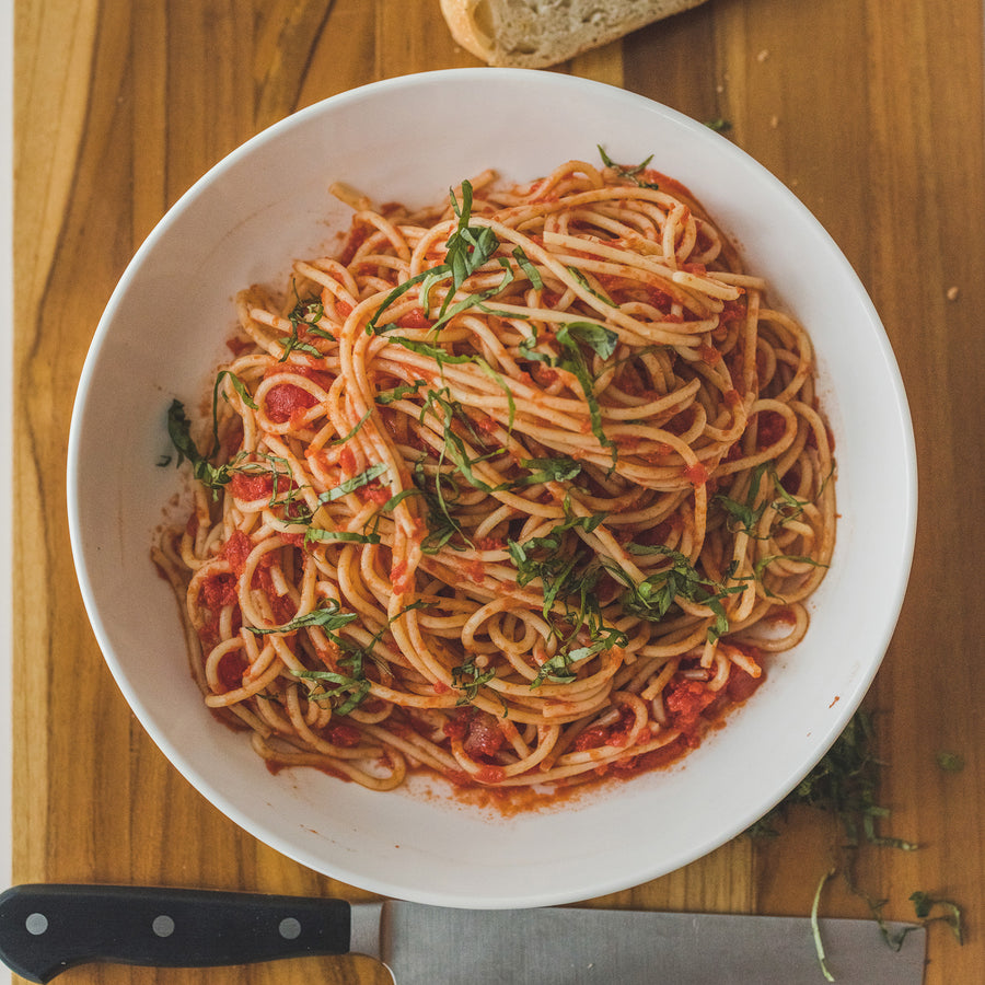 A bowl of spaghetti with tomato sauce